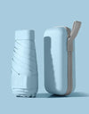 A solid color umbrella with a capsule box and a foldable umbrella for easy travel The umbrella is suitable for both sunny and r