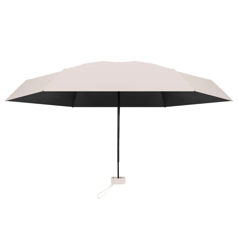 A solid color umbrella with a capsule box and a foldable umbrella for easy travel The umbrella