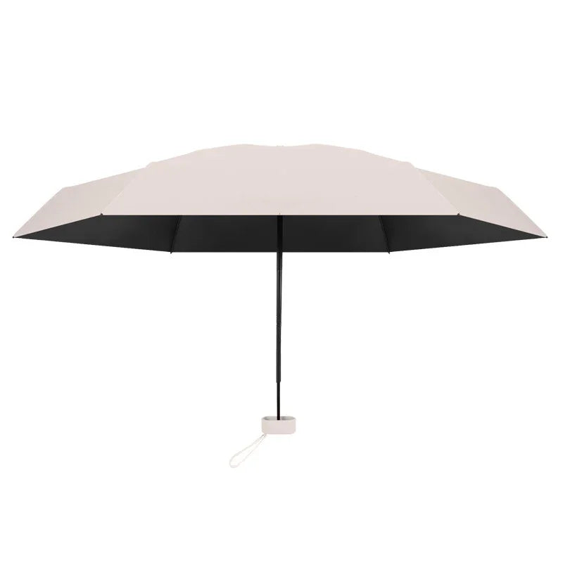 A solid color umbrella with a capsule box and a foldable umbrella for easy travel The umbrella is suitable for both sunny and r
