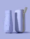 A solid color umbrella with a capsule box and a foldable umbrella for easy travel The umbrella is suitable for both sunny and r