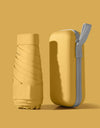 A solid color umbrella with a capsule box and a foldable umbrella for easy travel The umbrella is suitable for both sunny and r